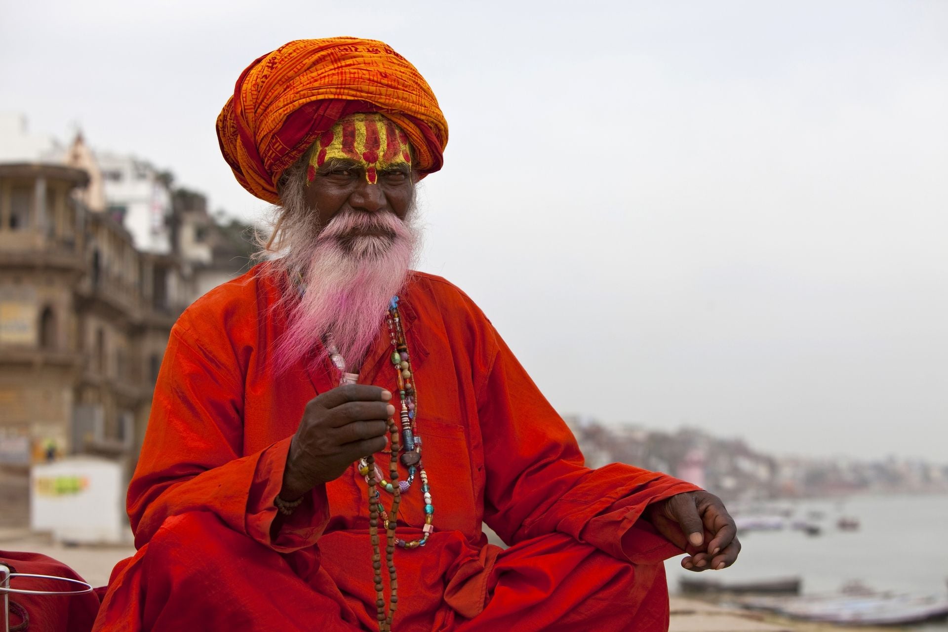 Sadhu at the ghats in Varanasi, India. With a pink beard from the traditional holi festival.