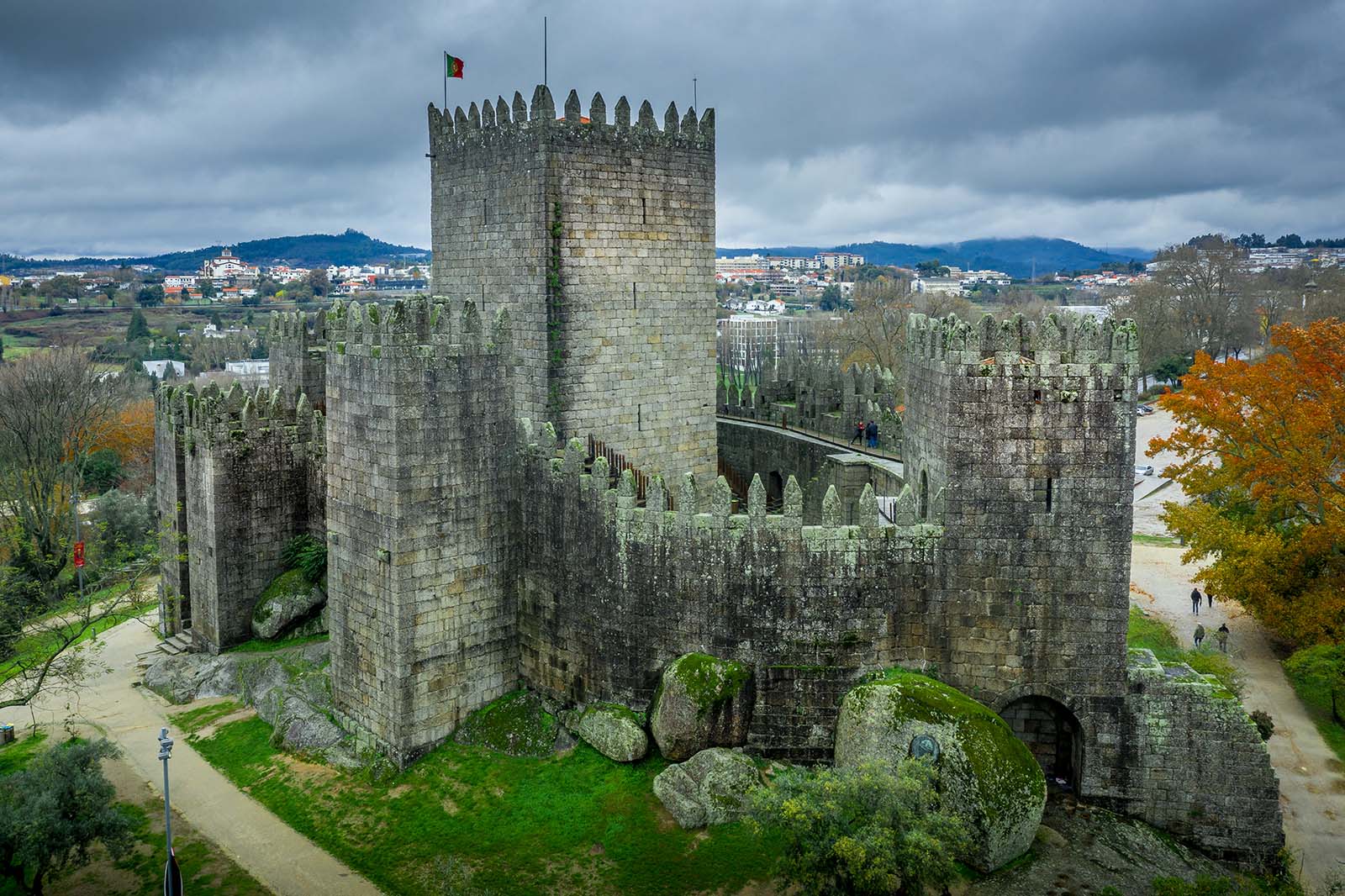 Aerial view of well-preserved medieval buildings hilltop, 10th-century Guimarães Castle © Shutterstock