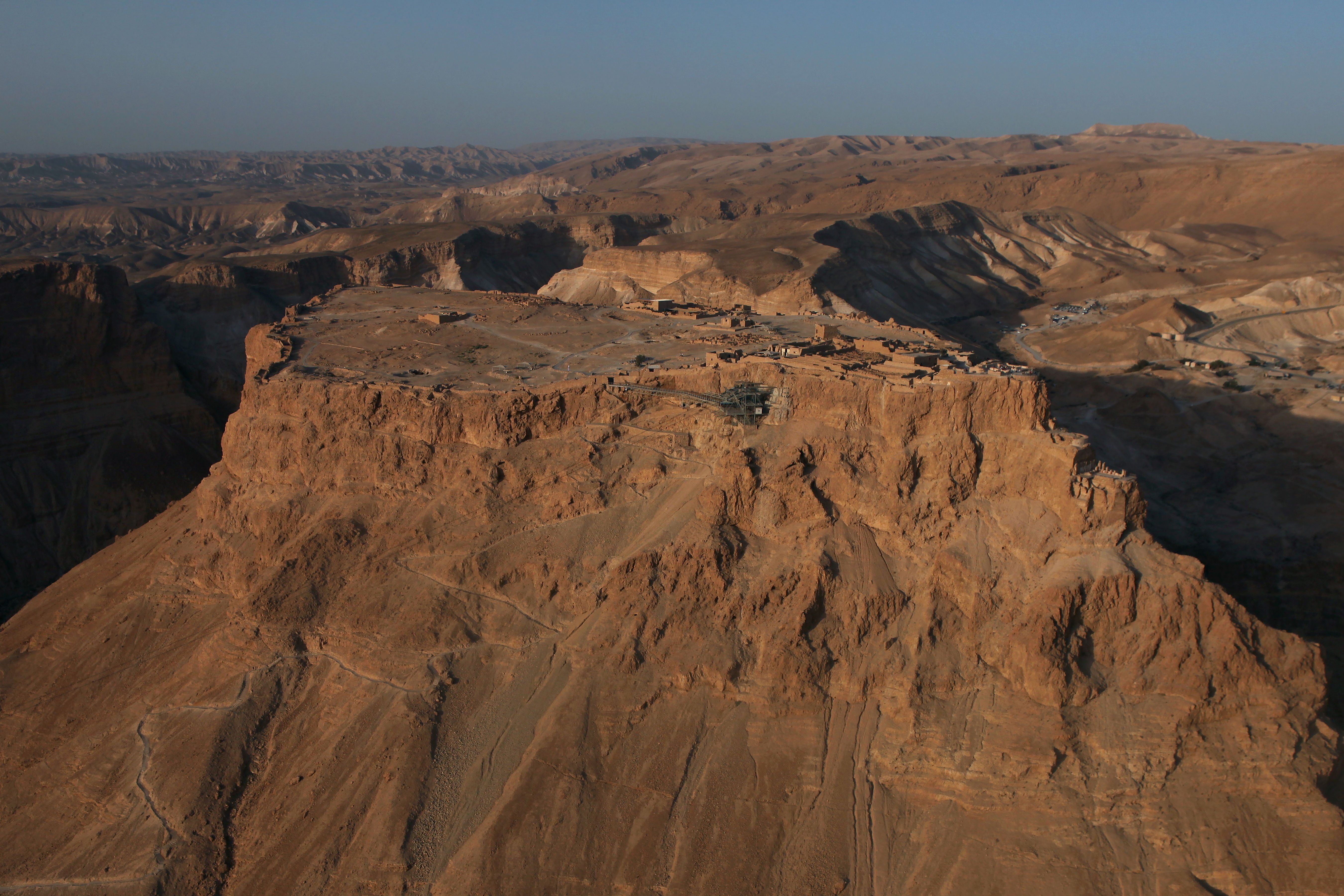 An aerial view of the ancient mountaintop fortress of Masada shortly after sunrise on the shores of the Dead Sea in southern Israel.