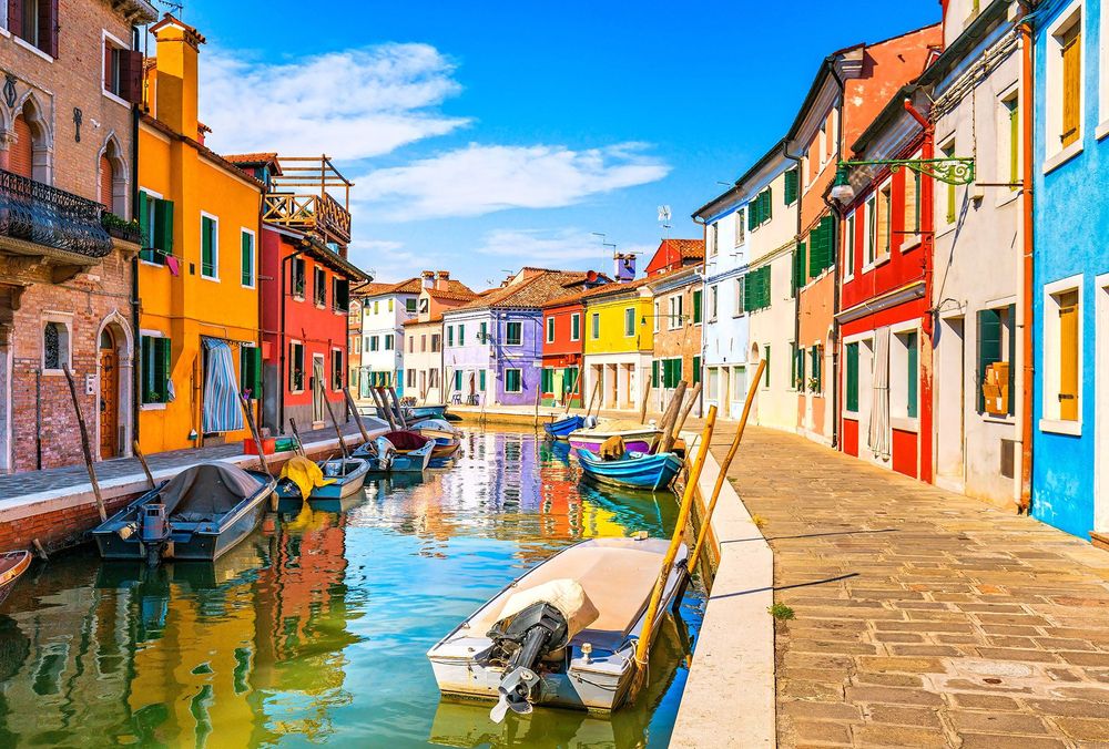 Venice landmark, Burano island canal, colorful houses and boats, Italy © StevanZZ/Shutterstock