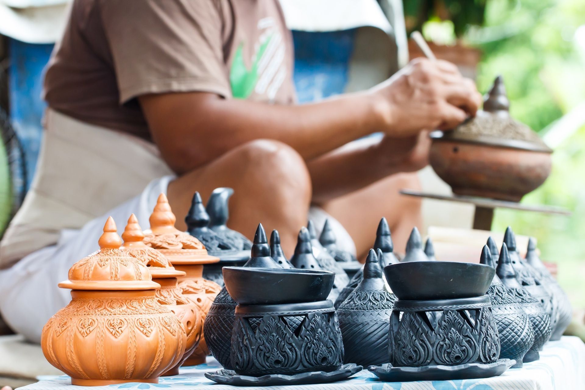 Pottery souvenir with craftspeople working background