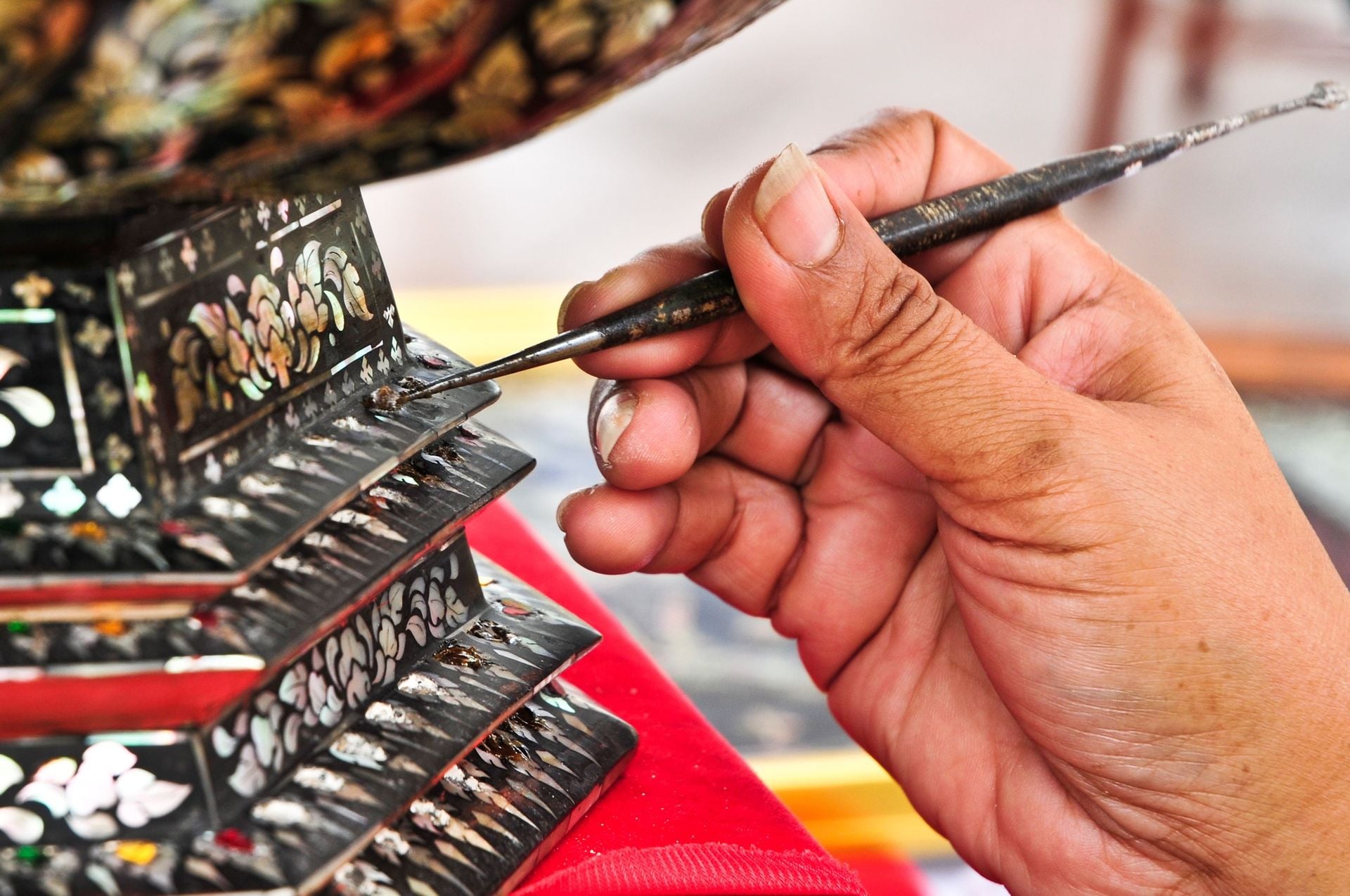 Artist while painting design lacquerware, Thailand.