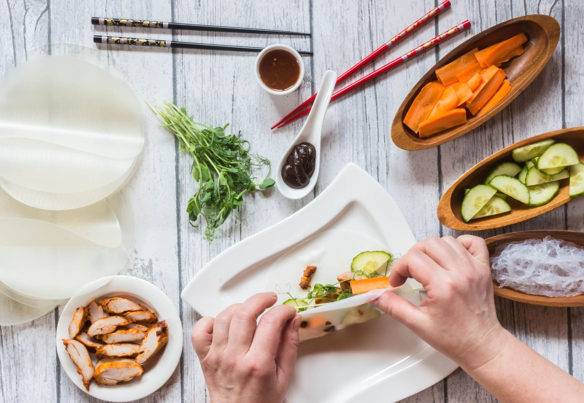 Cooking spring roll, top view, hands is mooving blur