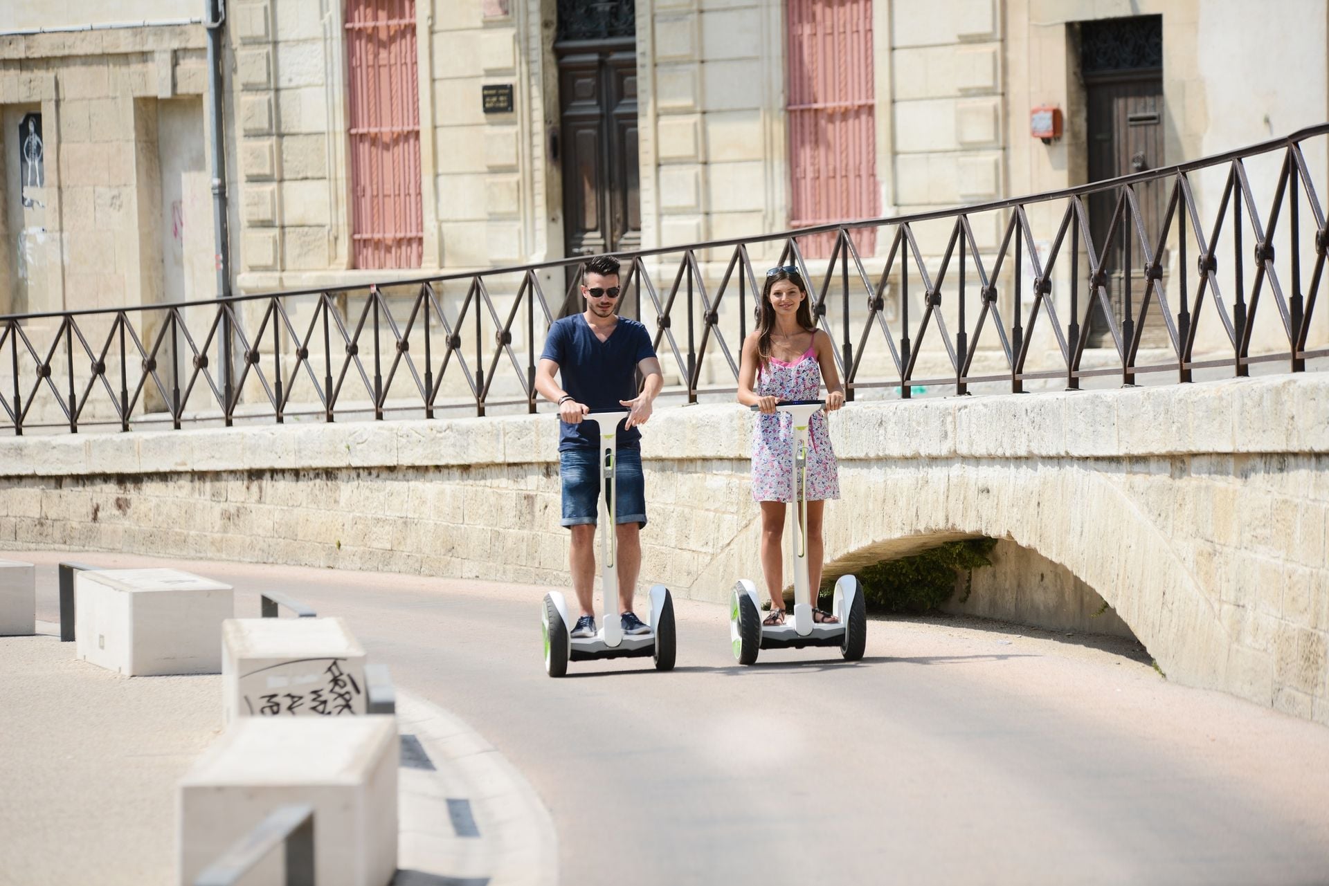 Happy young couple riding segway gyropode electric two wheels vehicle on a sightseeing tour