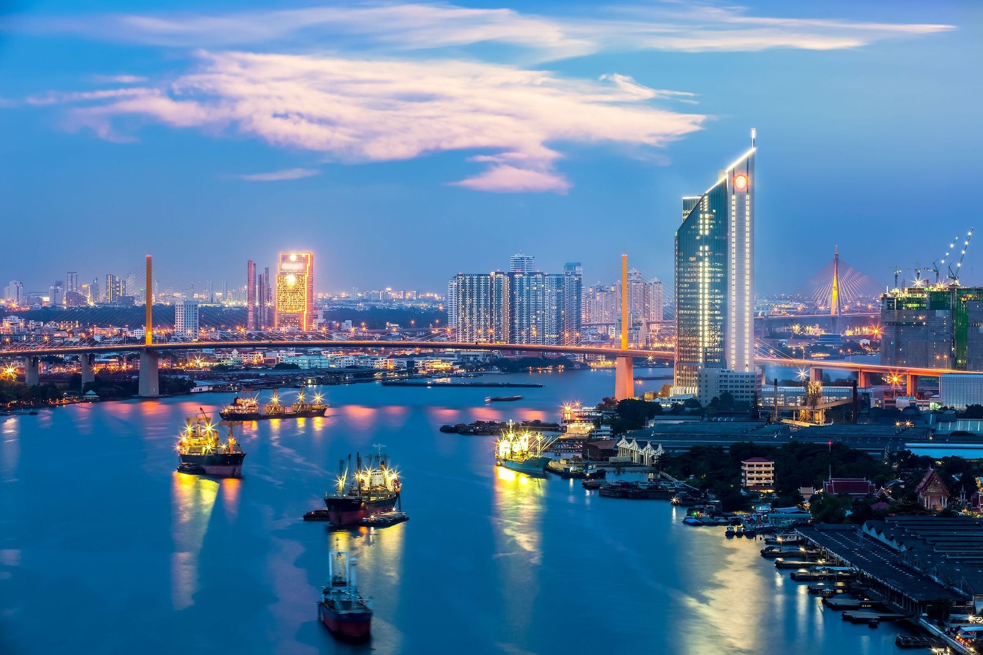 The Bridge across the river with Modern Building at dusk (Bangkok, Thailand)