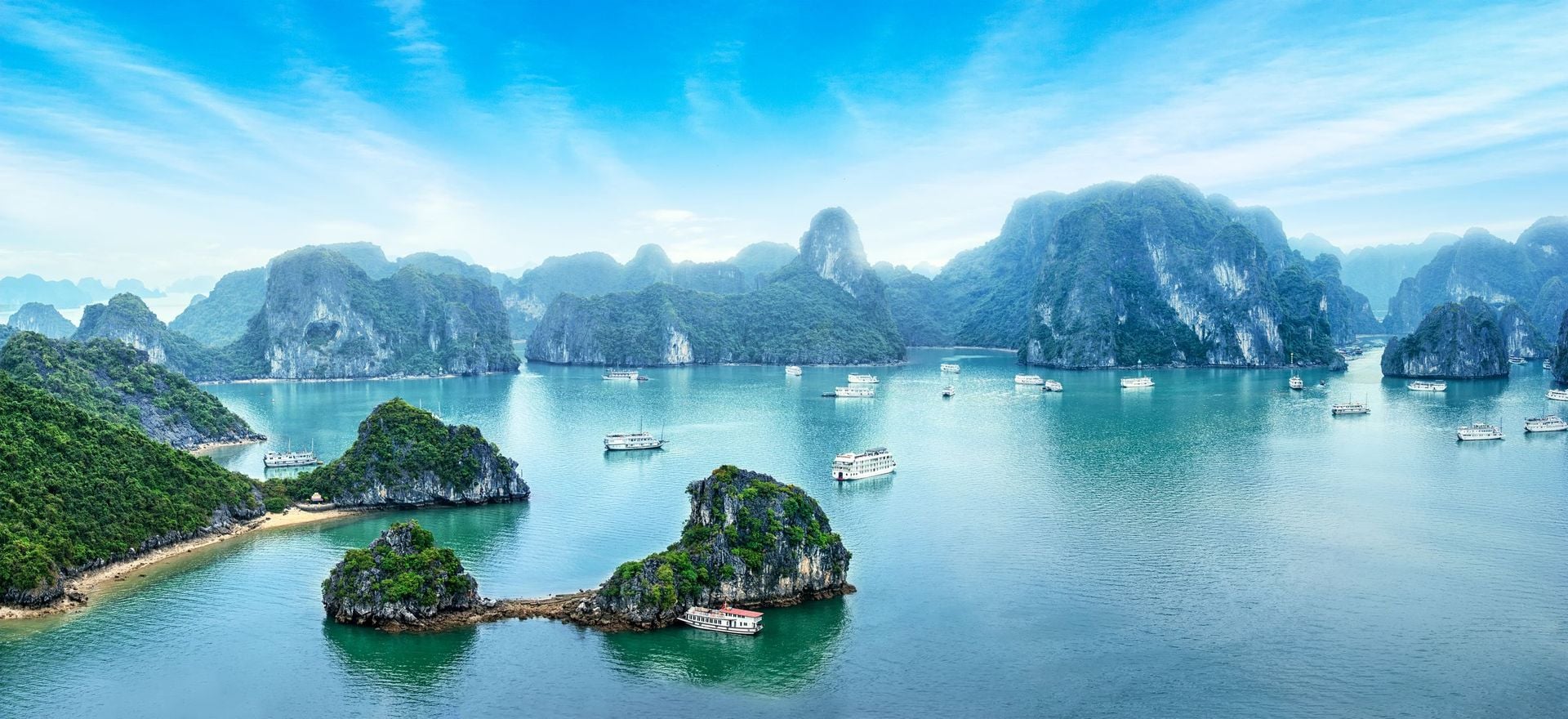 Tourist junks floating among limestone rocks at early morning in Ha Long Bay, South China Sea, Vietnam, Southeast Asia. Five images panorama