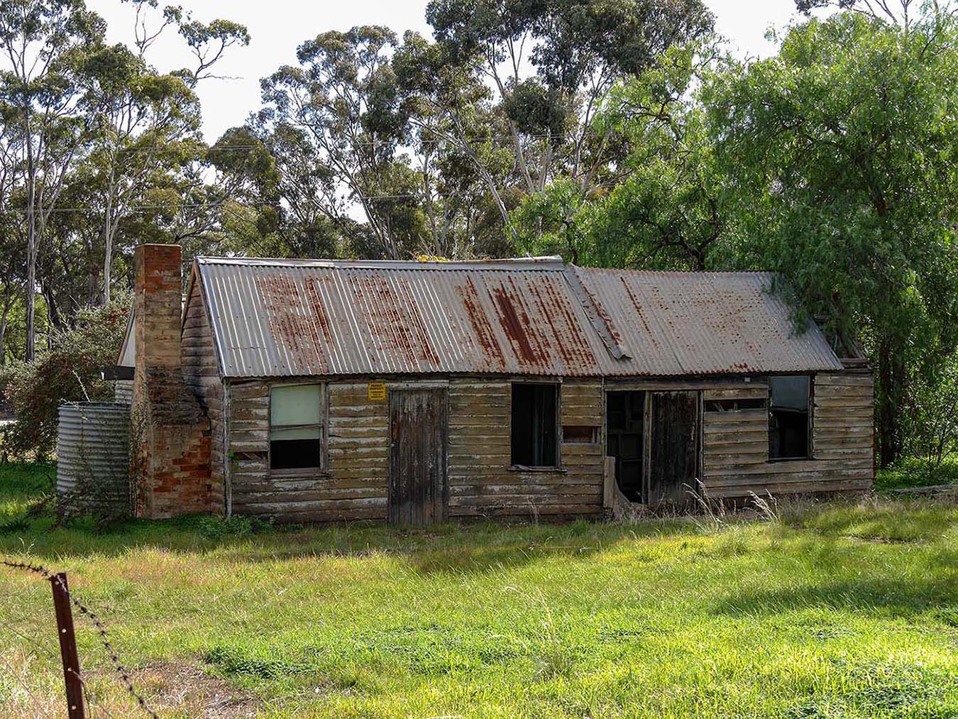 Llanelly Victoria Australia. An old derelict wooden house with a brick chimney and metal roof © Shutterstock