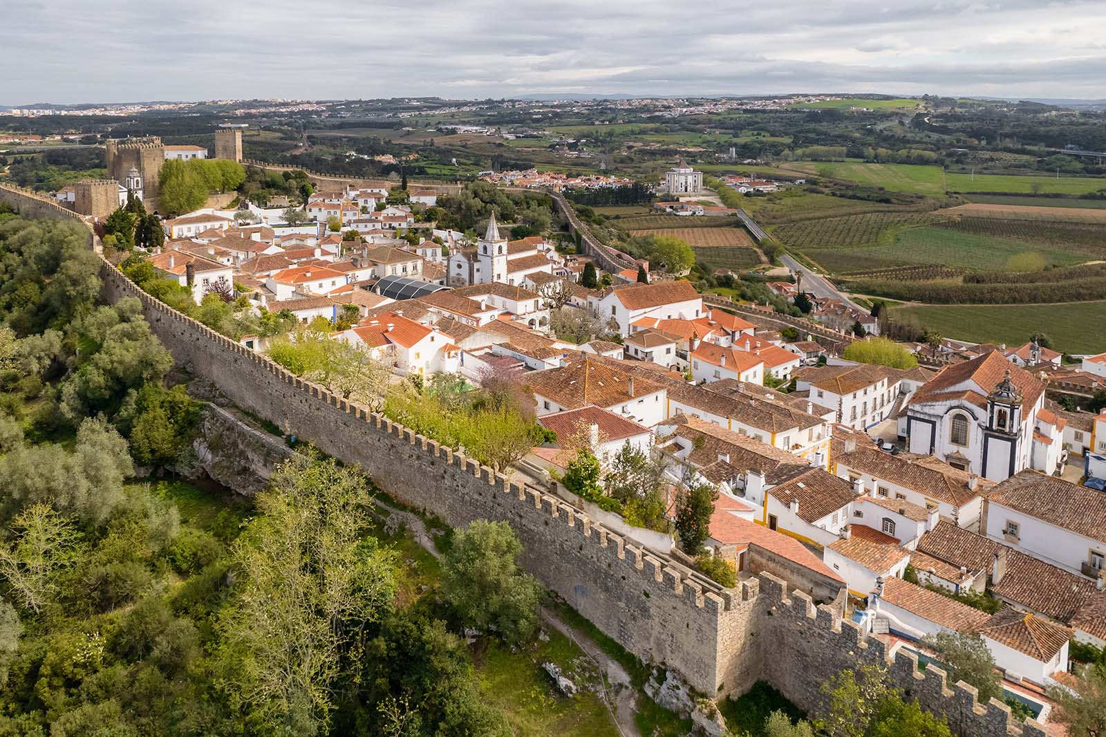 Aerial view of the historic walled town of Obidos, near Peniche, Portugal. Aerial shot of Obidos Medieval Town, Portugal © Shutterstock