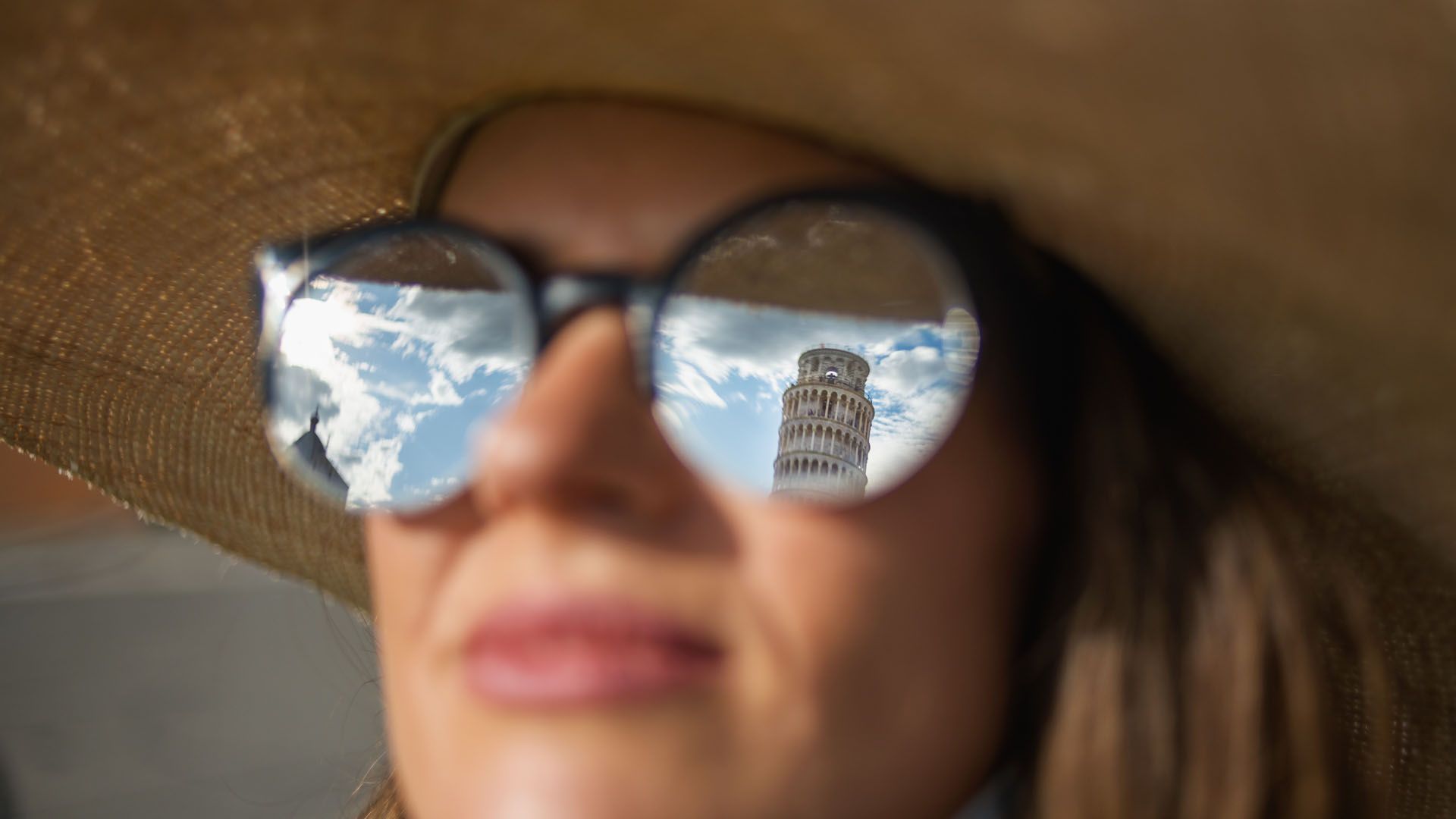 Leaning tower reflecting in glasses, Pisa, Italy © Alliance Images/Shutterstock