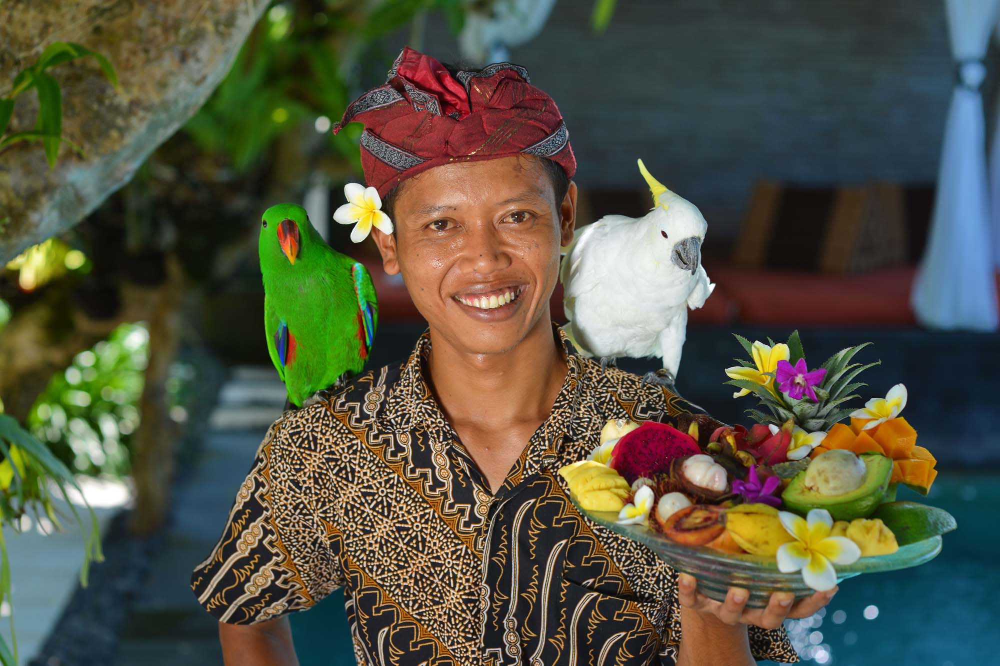 Asian waiter with a tray of tropical fruits in Bali