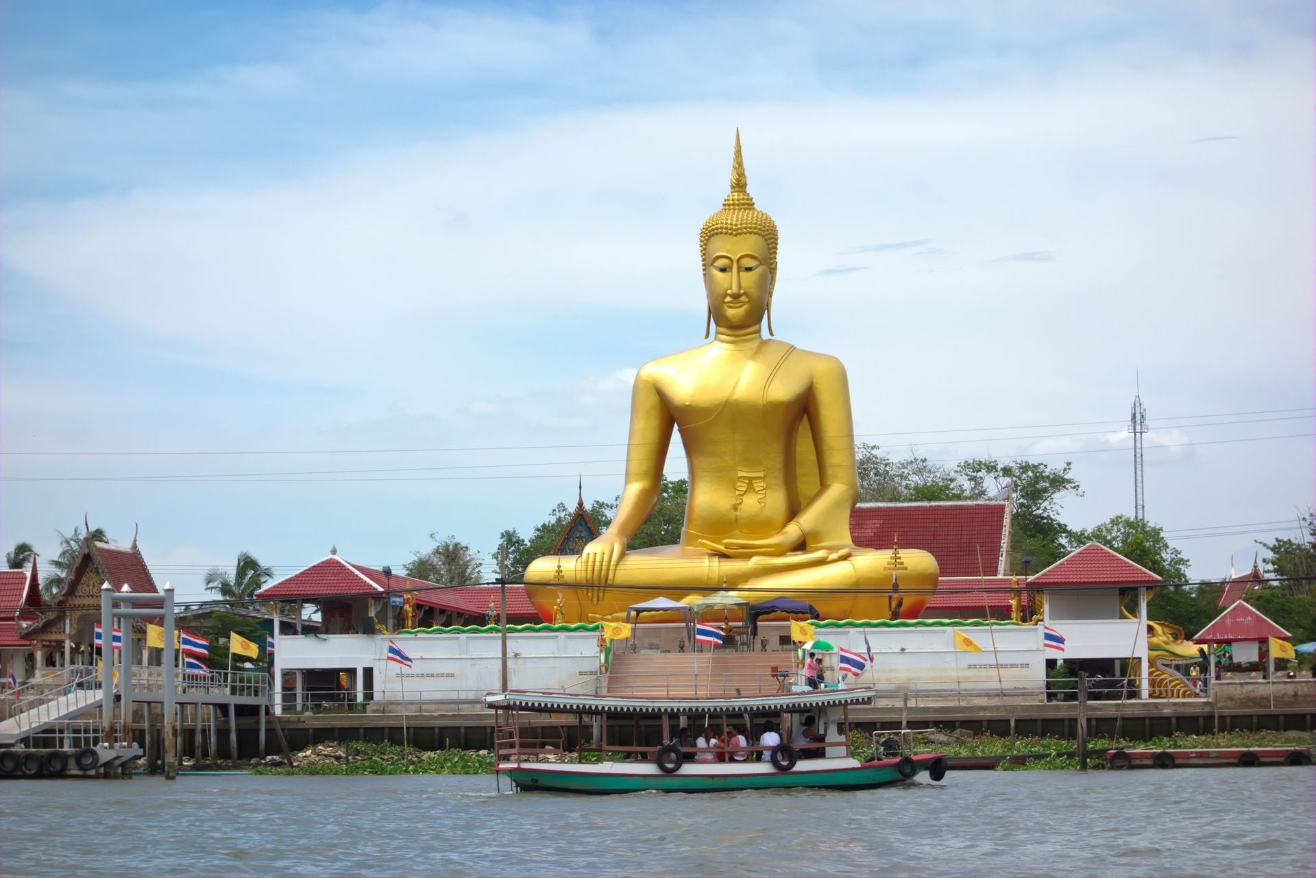 big golden buddha be side the Chao Phraya river, Nonthaburi province ,Thailand .