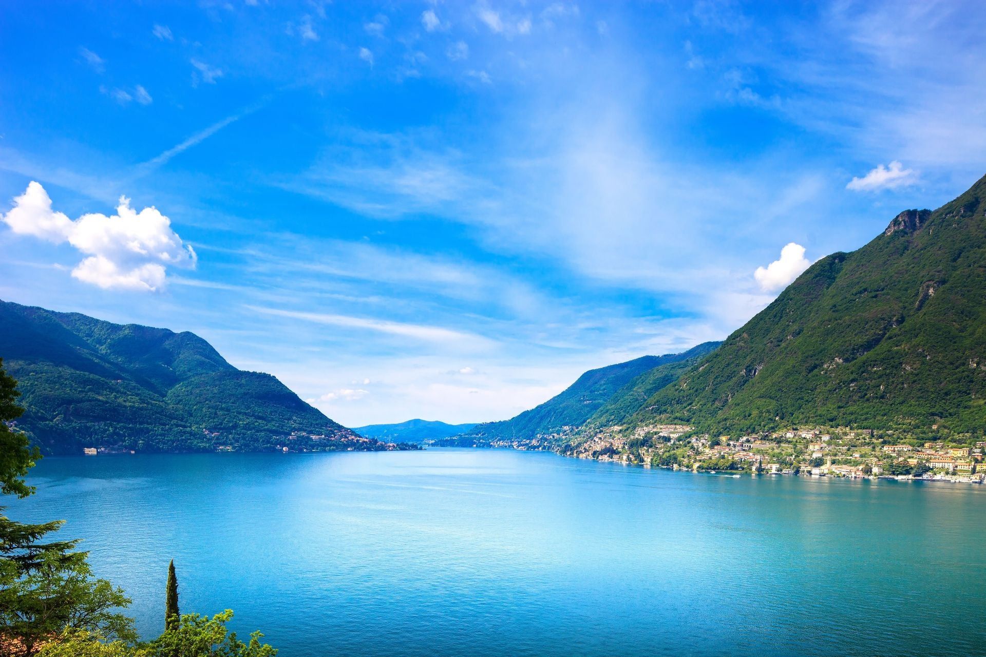 Como Lake landscape. Cernobbio village, trees, water and mountains. Italy, Europe.