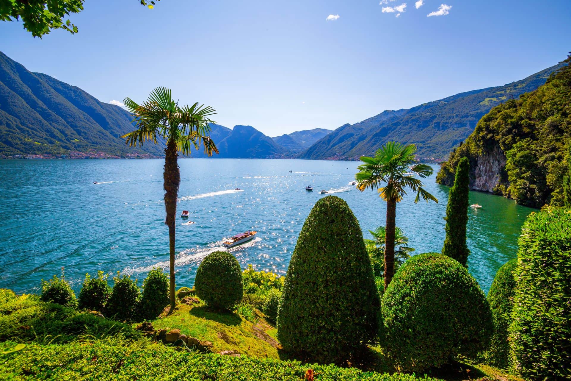 Como Lake landscape. Cernobbio village, trees, water and mountains. Italy, Europe.