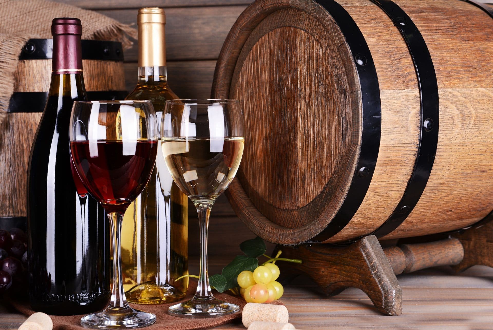 Different wine on table on wooden background