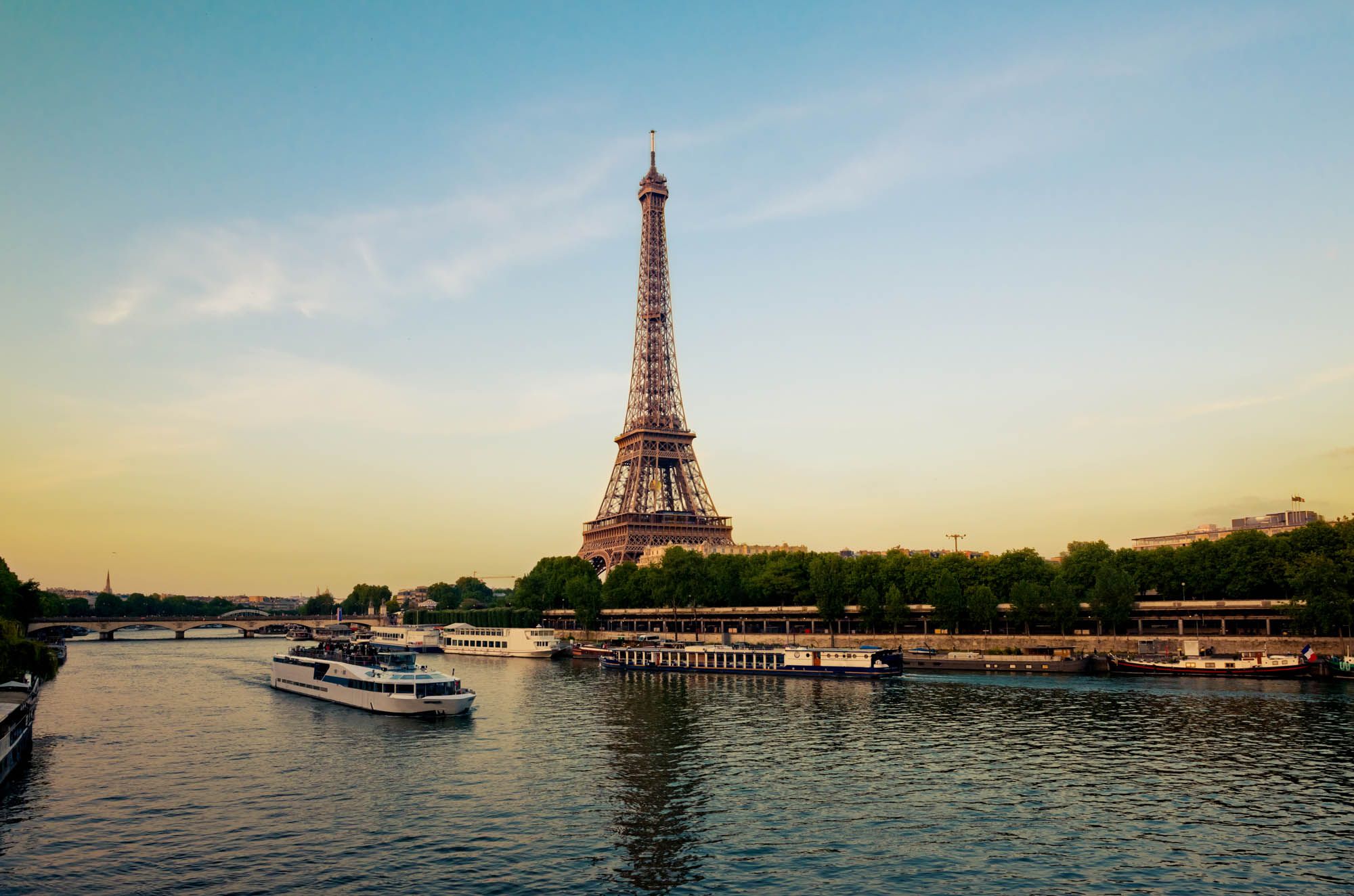 Eiffel Tower with boats in evening Paris