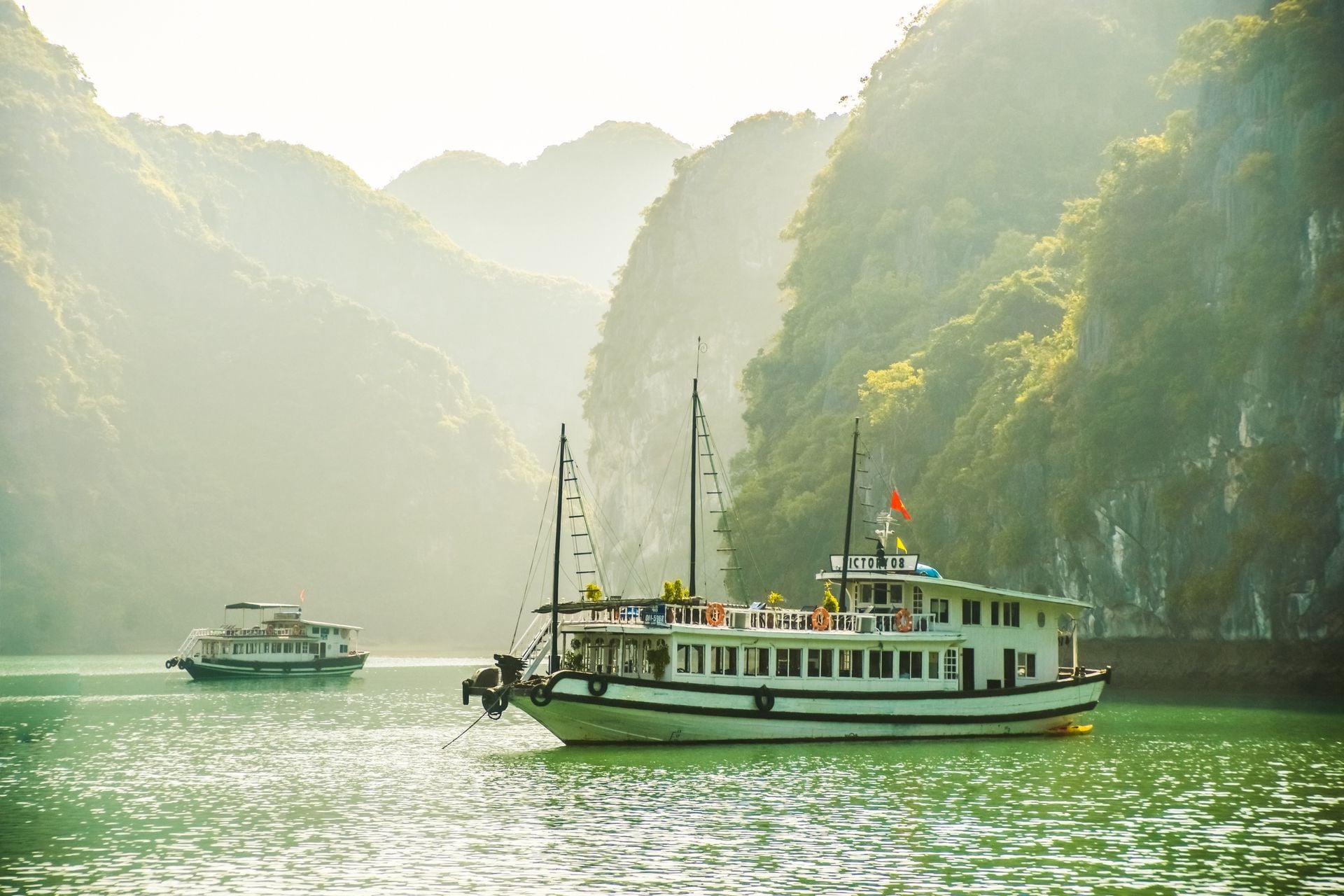 Beautiful view on tourist boats among limestone rocks of Ha Long Bay, Vietnam