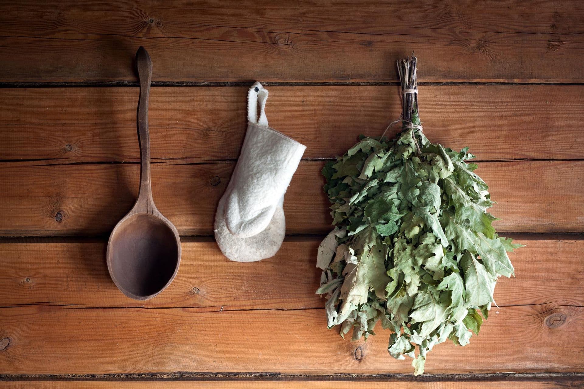 wooden wall of the sauna and oak bunch in Finland
