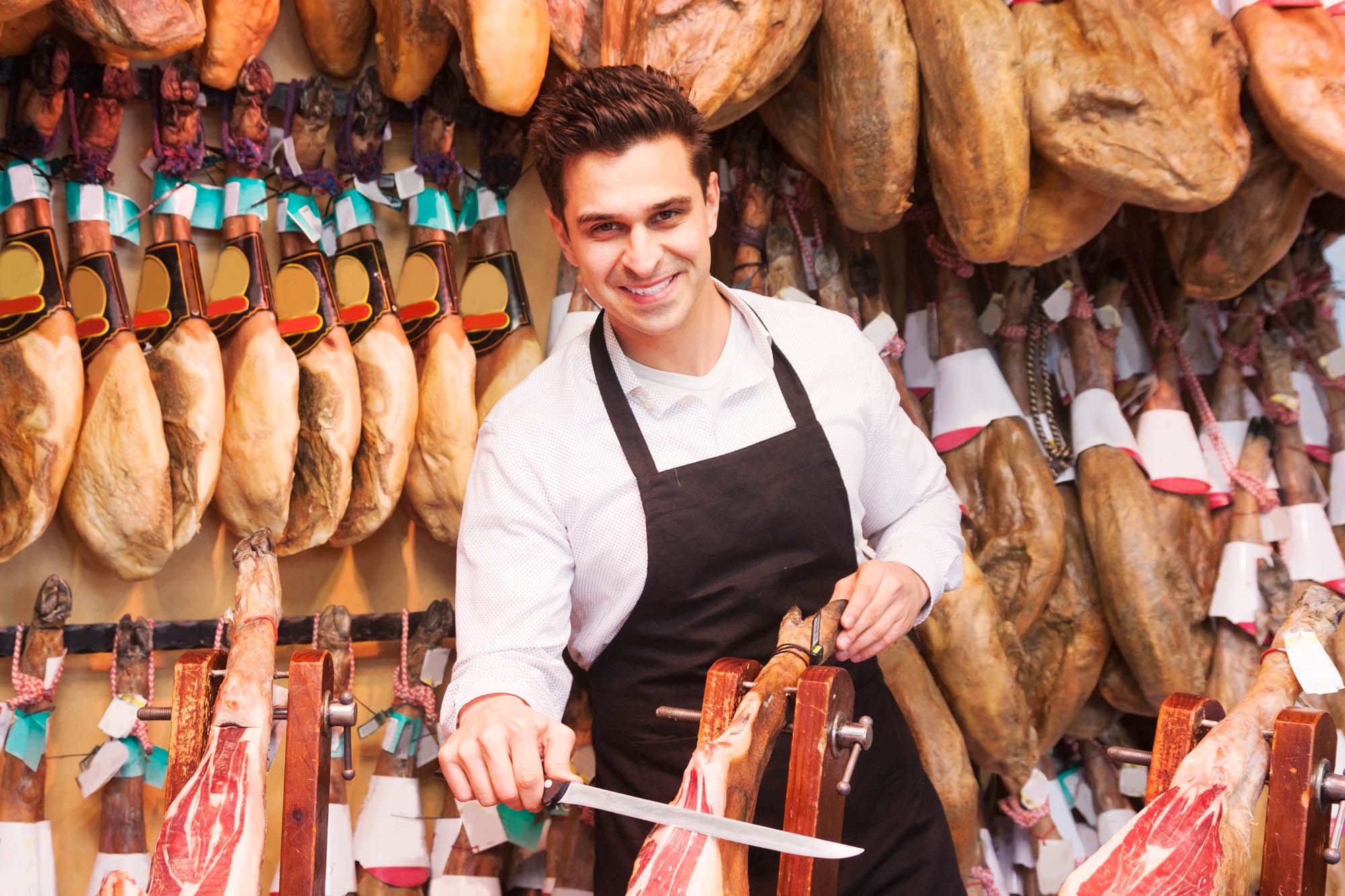 Young sellers offer ham in the shop