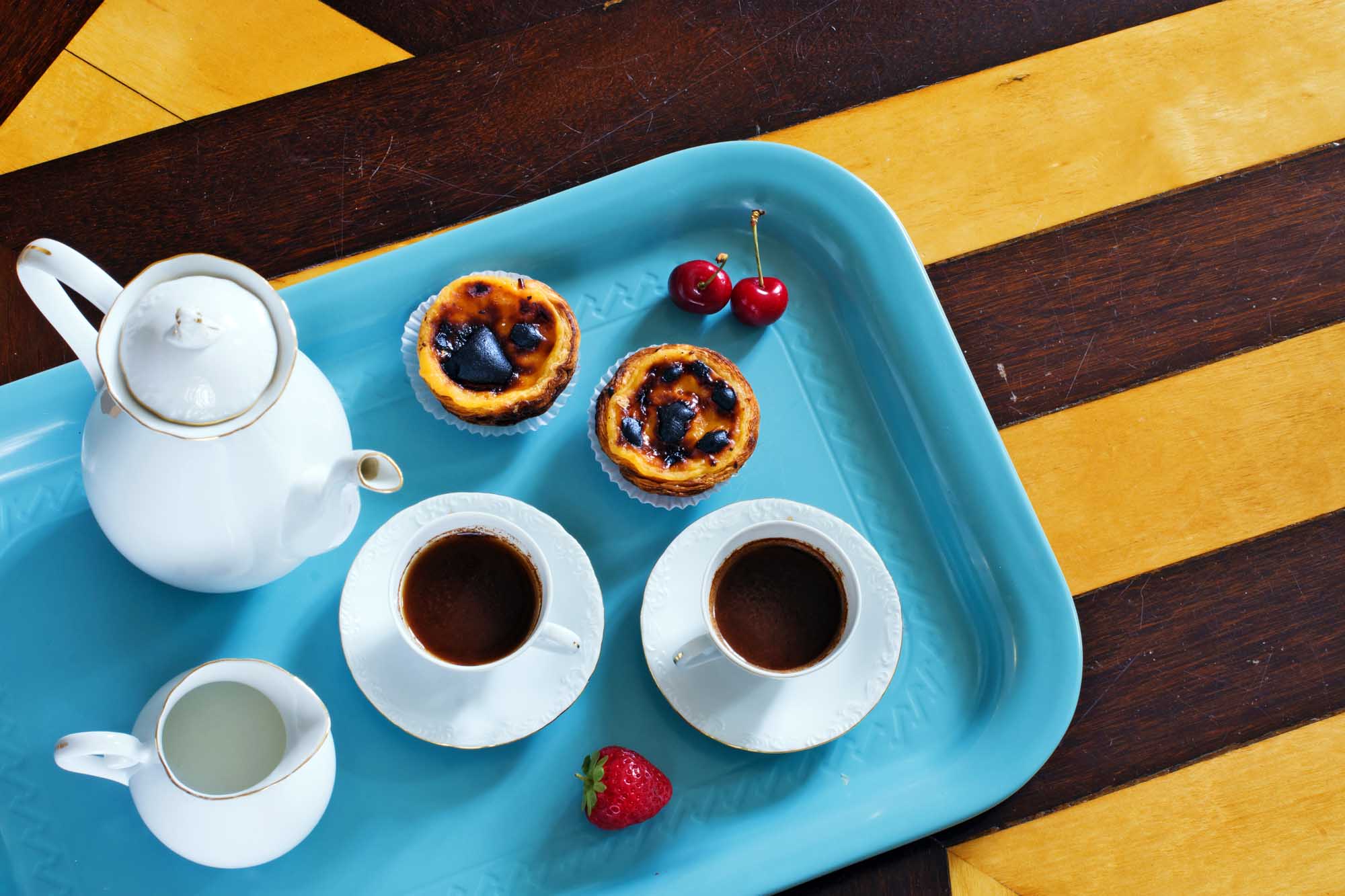 Portuguese breakfast. Room service in hotel in Portugal. Black coffee, pasteis de nata, strawberries.