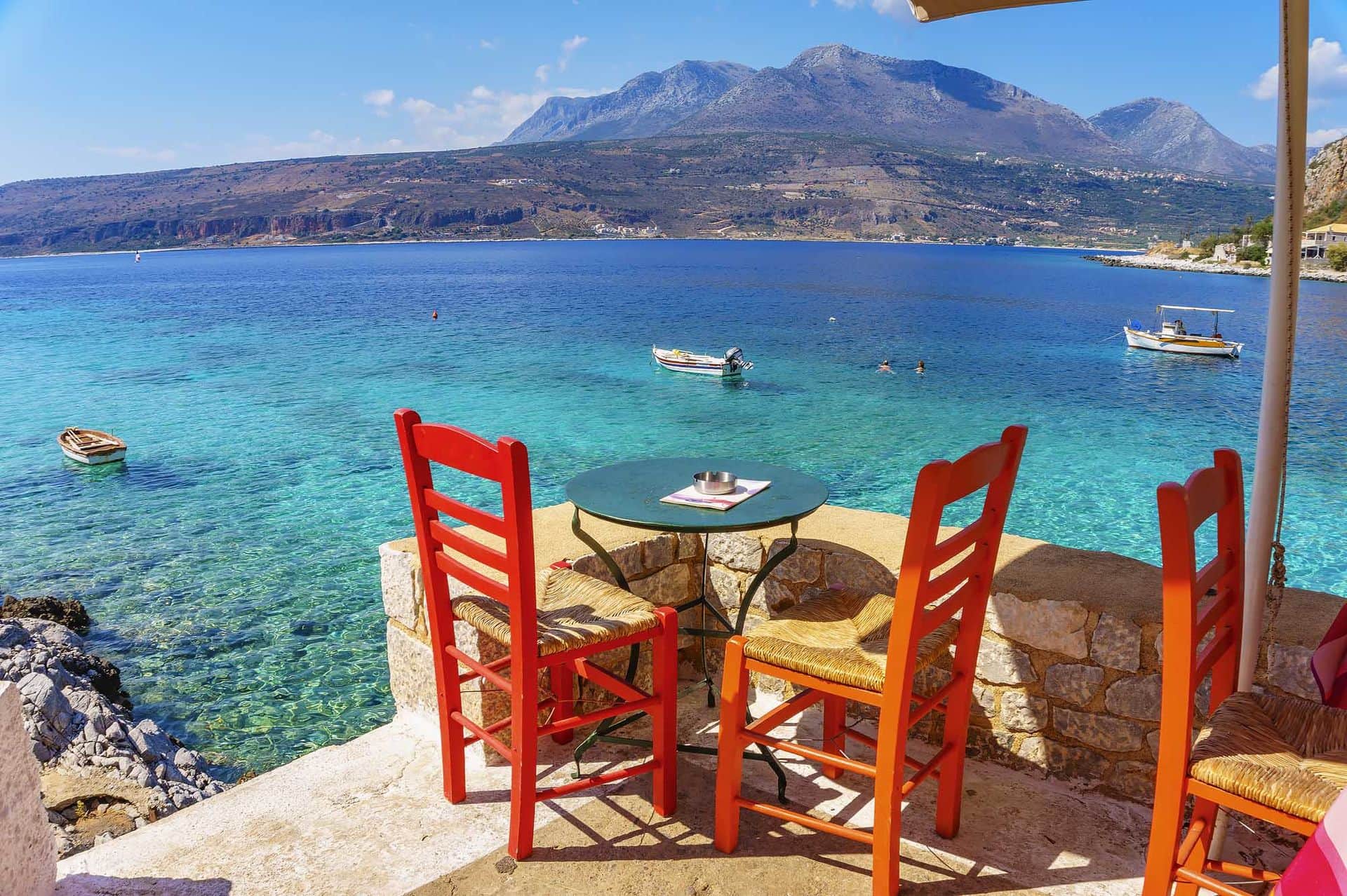 Ttraditional chairs with a table near the beautiful Greek sea at Limeni village located in Laconia - Greece.