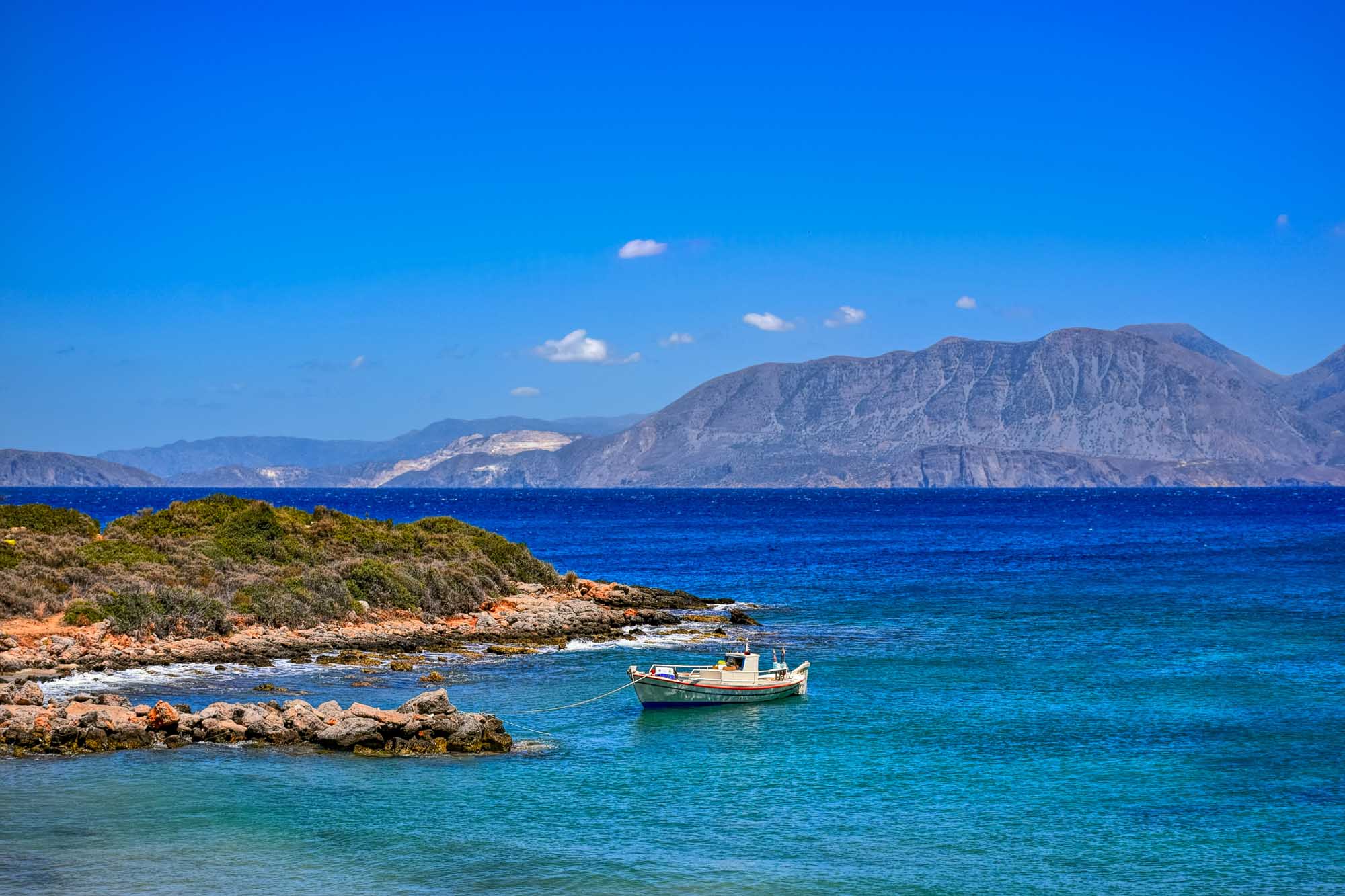 Alone fishing boat moored near Ammoudara beach. Crete, Greece.