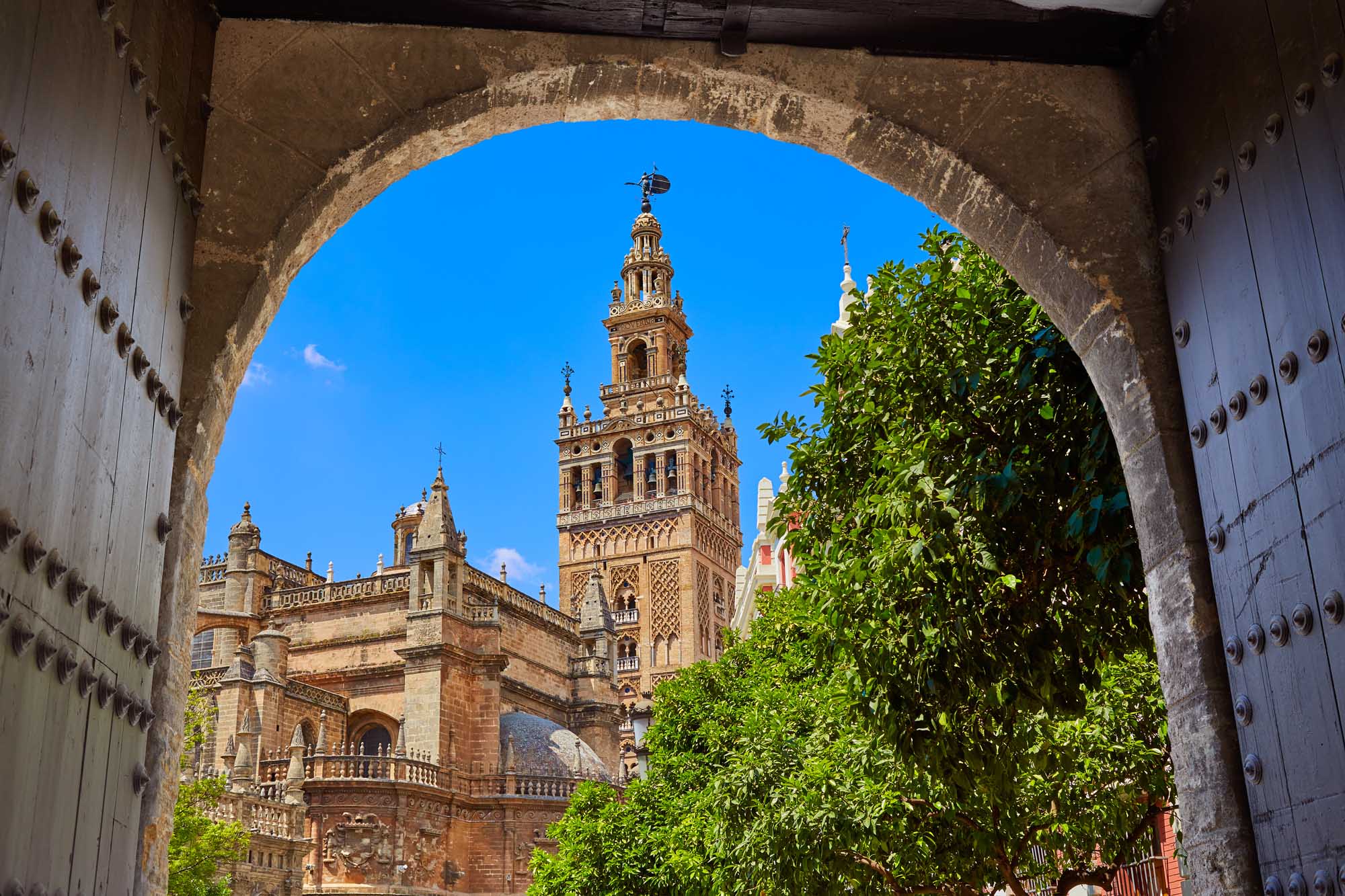 Seville cathedral Giralda tower from Alcazar arch door of Sevilla Andalusia Spain