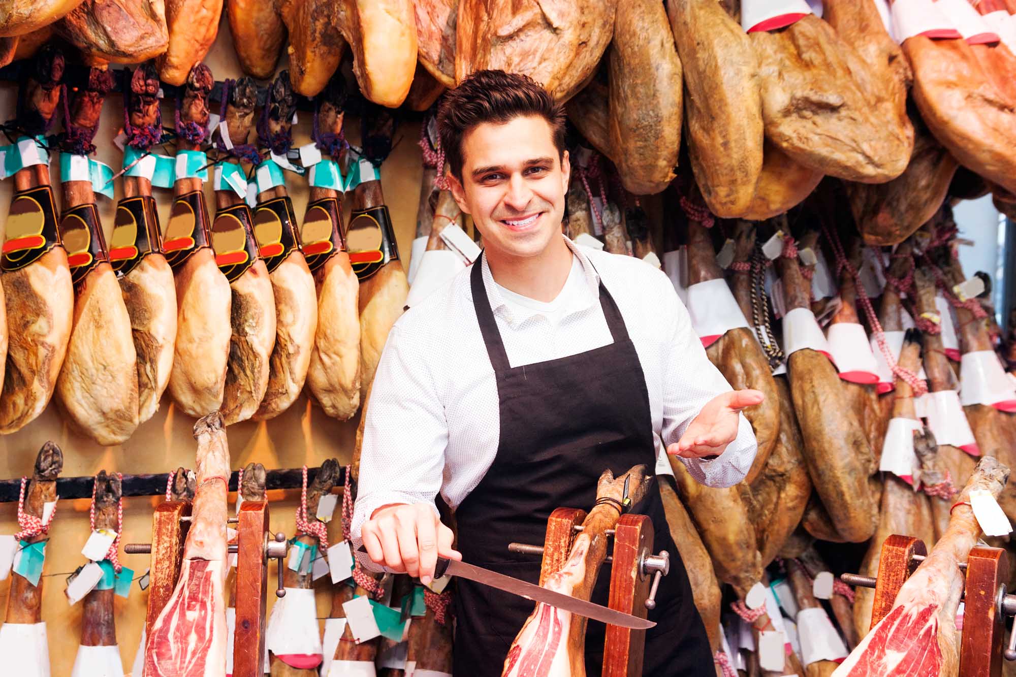 portrait of a smiling salesperson in the store jamon