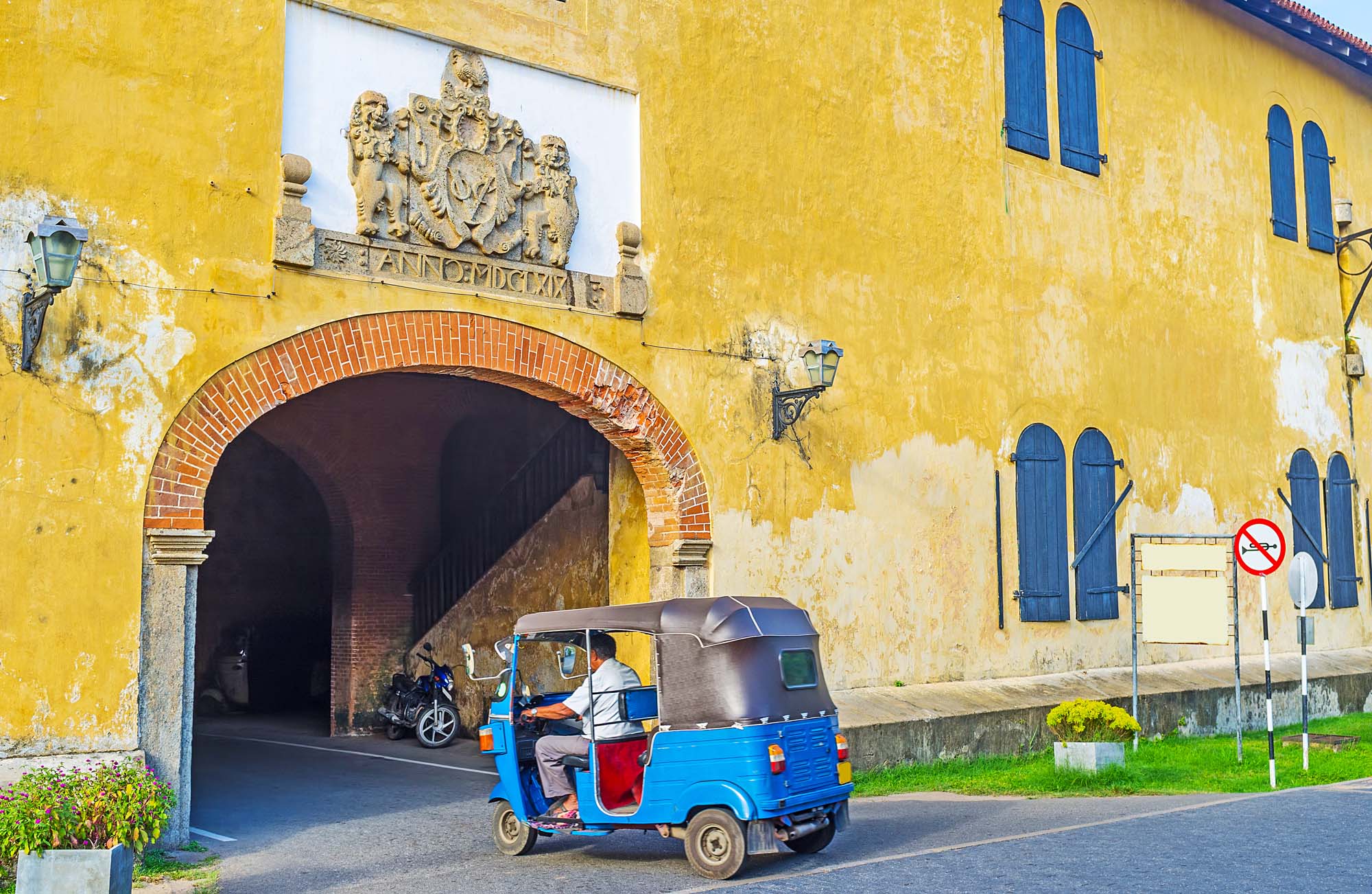 The tuk tuk riding to the exit of Galle Fort through the Old Gate, Sri Lanka.