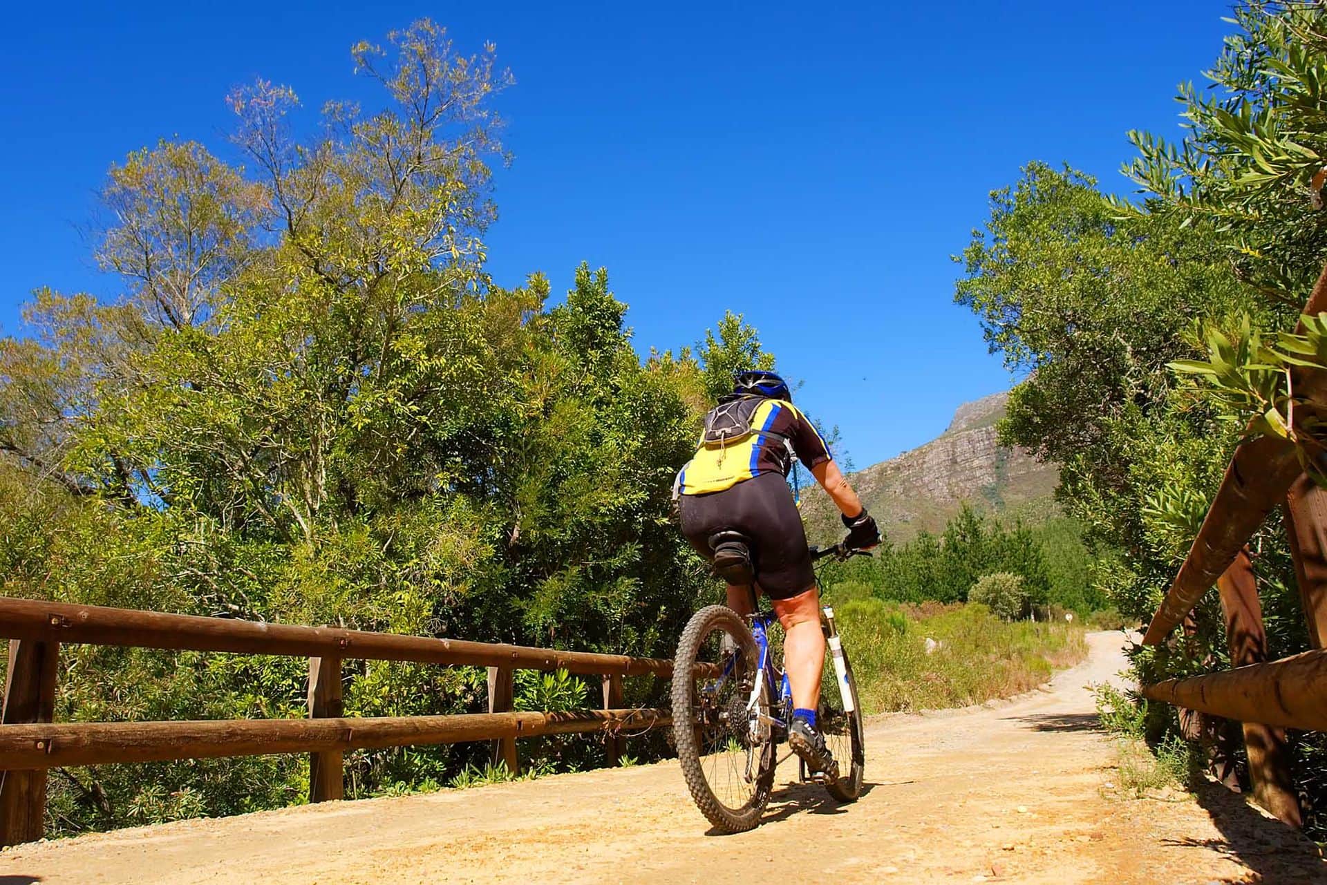Girl rides a bike in mountains. Shot in August in Jonkershoek Nature Reserve, Stellenbosch, Western Cape, South Africa.